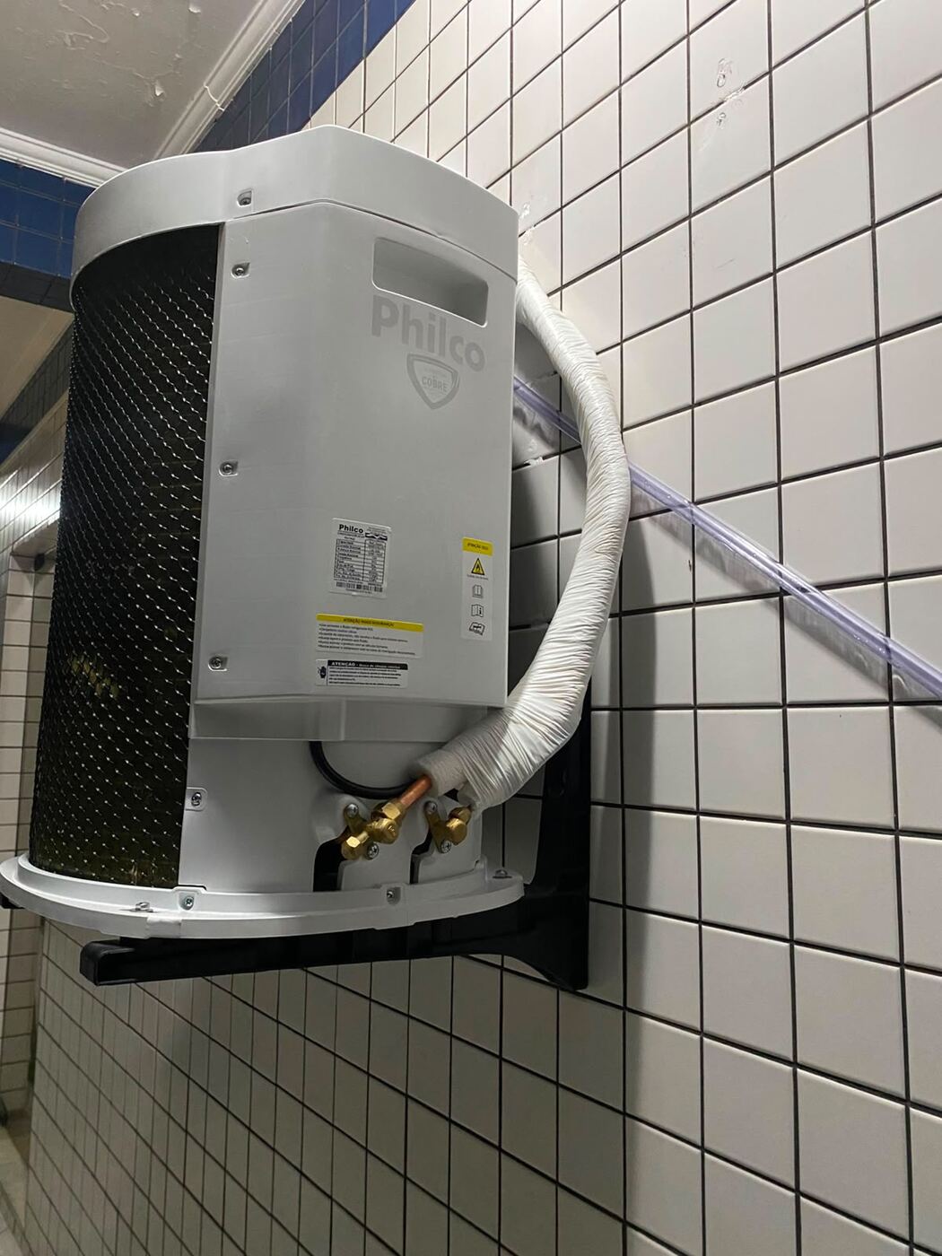 Condensadora Philco com tubulação isolada em parede azulejada