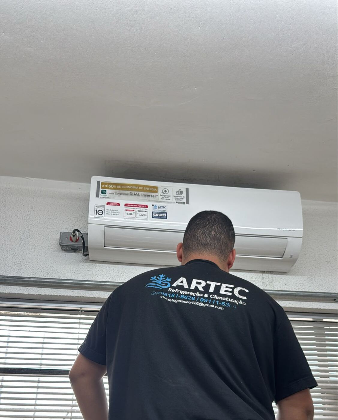 Técnico da ARTEC em frente a um ar condicionado LG